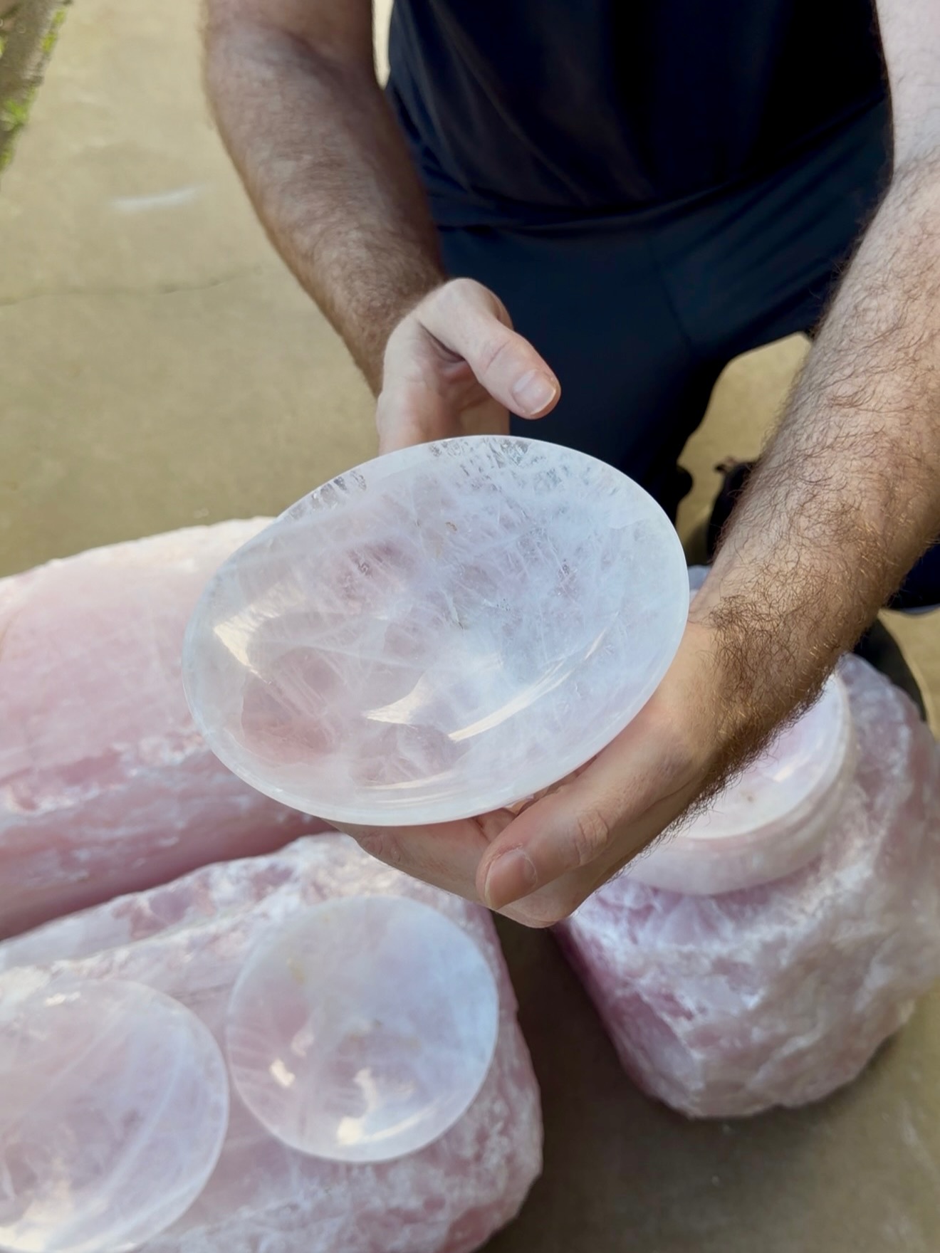 Close de um prato de quartzo rosa leitoso, mostrando a cristalização natural e o brilho da pedra polida